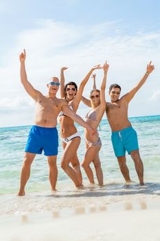 young happy friends havin fun on the beach summer holiday