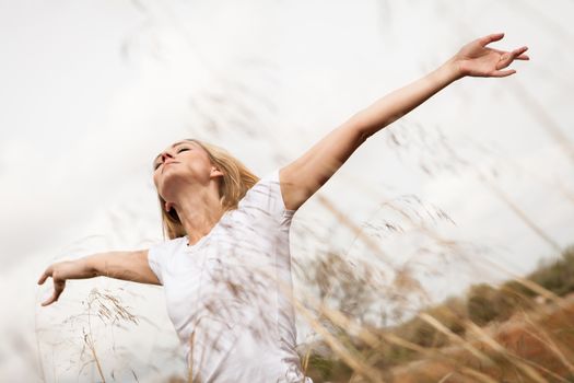 young happy attractive woman arms wide open nature outdoor breathing 