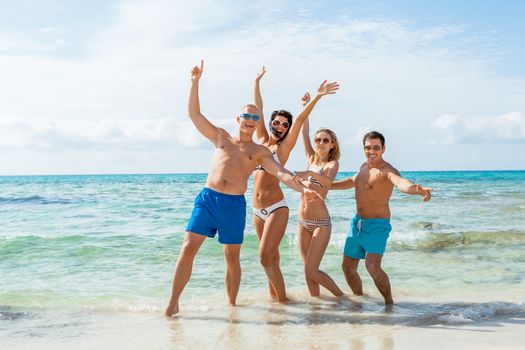 young happy friends havin fun on the beach summer holiday