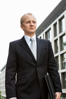 smiling successful business man in black suit outdoor business male