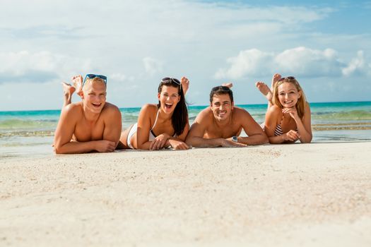 young happy friends havin fun on the beach summer holidays lifestyle