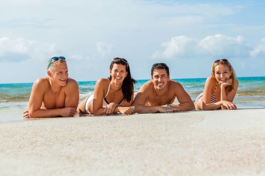 young happy friends havin fun on the beach summer holiday