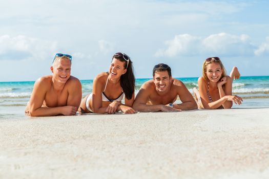 young happy friends havin fun on the beach summer holiday