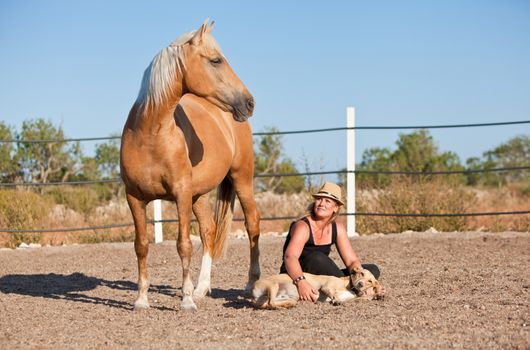 young woman training horse outside in summer choreography 