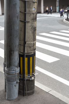 Electricity post in japan beside a crosswalk look tidy