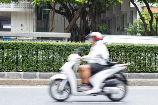 motorcycle rider in the city traffic in motion blur.