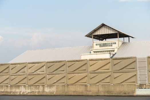 Noise barrier wall beside the highway to protect resident from noise