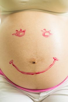 Smile Paint on pregnant woman abdomen, belly