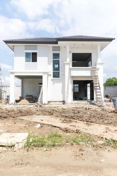 House under construction with many construction equipment were left in