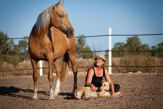 young woman training horse outside in summer choreography 