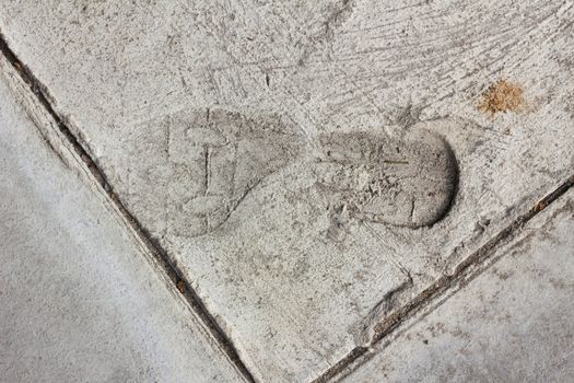 Man footprints on concrete track.