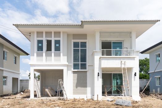 House under construction with many construction equipment were left in