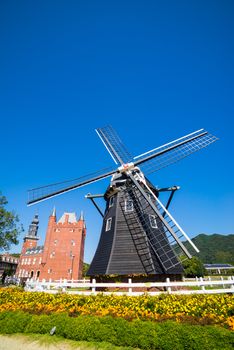 Windmill at Huis Ten Bosch stand in a bright and clear sky, Japan