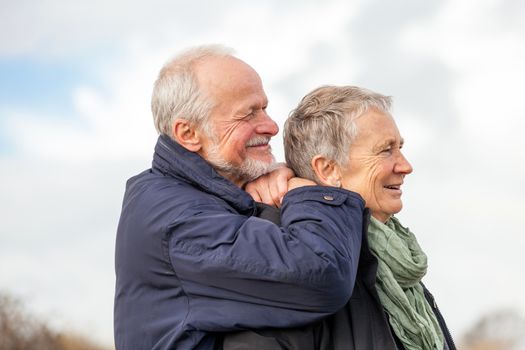 happy elderly senior couple walking on beach healthcare recreation