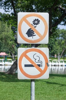 no smoking and do not pick flower, metal sign in the park