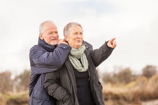 happy senior couple elderly people together outdoor in autumn winter