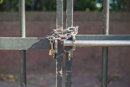 Locked padlock with chain bound to the front door