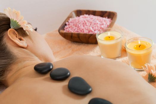 attractive healthy caucasian woman hot stone massage wellness  spa therapy