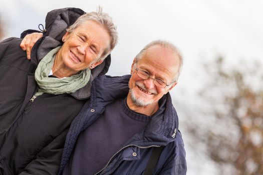 happy mature couple relaxing baltic sea dunes in autumn