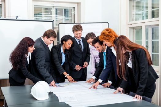 business people discussing architecture plan sketch in office