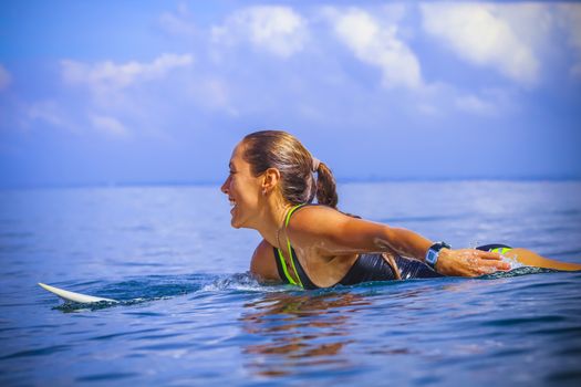 Surfer girl on Amazing Blue Wave, Bali island.