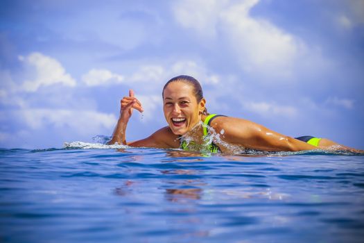 Surfer girl on Amazing Blue Wave, Bali island.