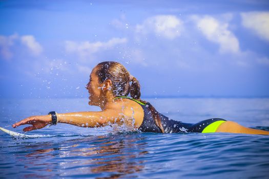 Surfer girl on Amazing Blue Wave, Bali island.