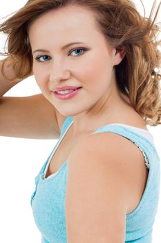 Natural portrait of a pretty young woman with long tousled hair and a sincere gentle expression, head and shoulders isolated on white