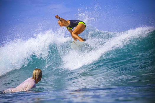 Surfer girl on Amazing Blue Wave, Bali island.