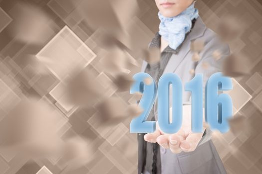 Concept of 2016, business woman holding a 3d text.