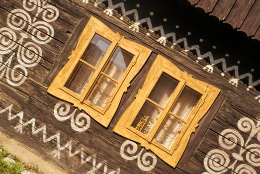 Painted facade of traditional wooden house in Slovakia in famous village of Cicmany