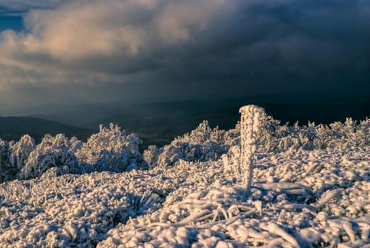 Dramatic dense clouds above white winter in mountains of Slovakia