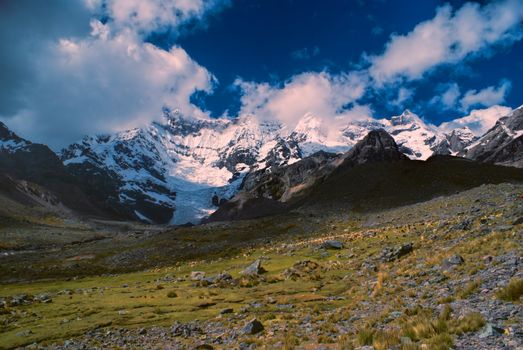 Scenic peaks and herd of llamas in Ausangate in Peru, south american Andes