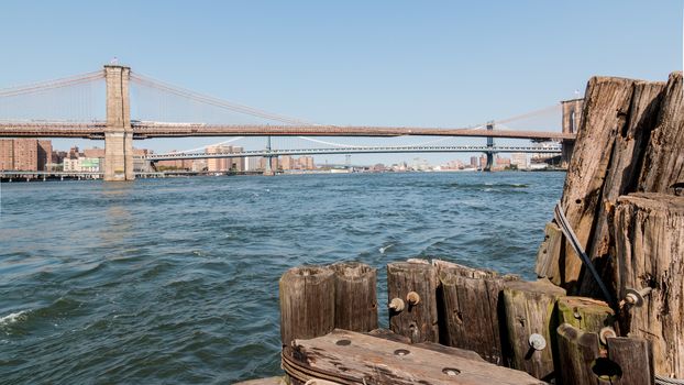 A view of Brooklyn bridge with Manhattan and Williamsburg bridge in the background