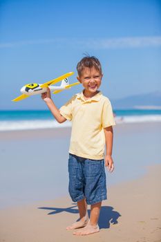 Beach kid boy kite flying outdoor coast ocean