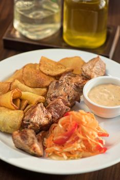 Grilled pork, baked potatoes and vegetable salad