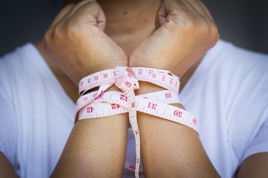 woman's hands gets tied up with tapeline, with vignette
