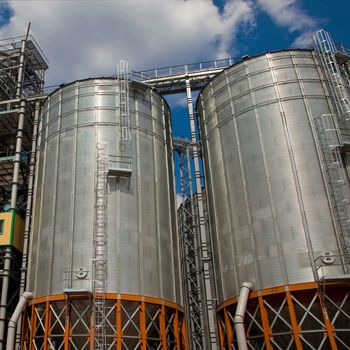 Towers of grain drying enterprise. metal grain facility with silos