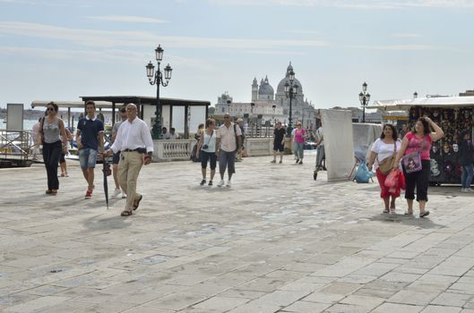 Some tourists walking along the Grand Canal