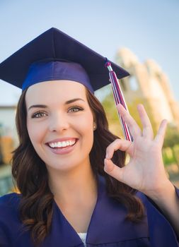 Happy Graduating Mixed Race Woman In Cap and Gown Celebrating on Campus.