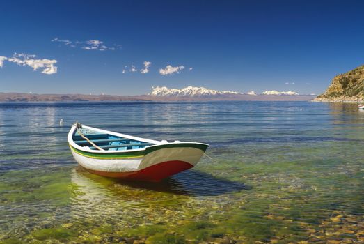 Small boat on the scenic coast of Isla del Sol, island on lake Titicaca in Bolivia