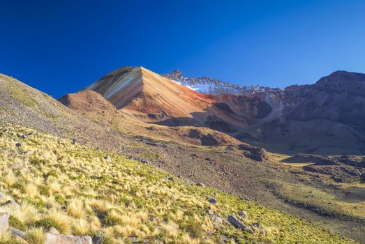 Scenic colored mountains near salt plateau Salar de Uyuni in Bolivia, South America          