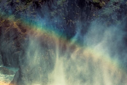 Rainbow in the mist over waterfall                