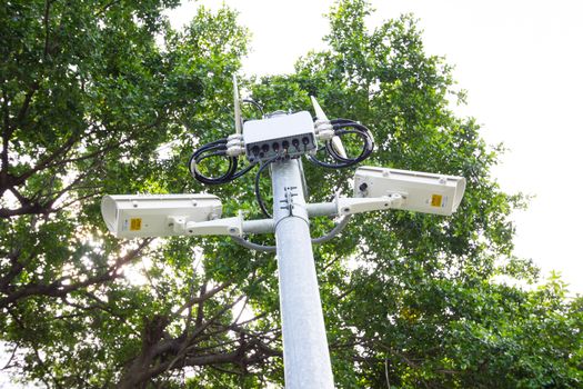 two security surveillance cameras near green forest.