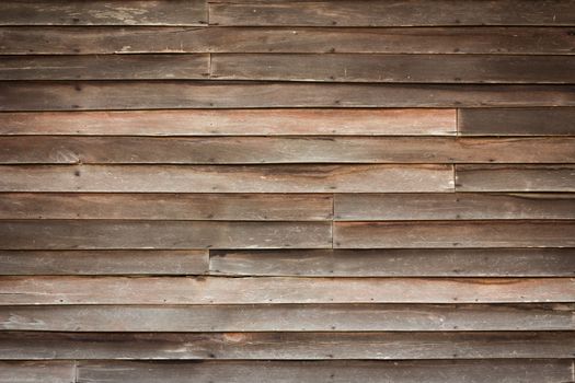 Perfectly lit wooden background with weathered wood and rusty nails
