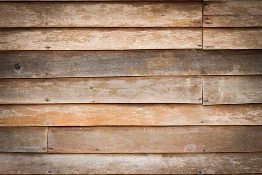 Perfectly lit wooden background with weathered wood and rusty nails
