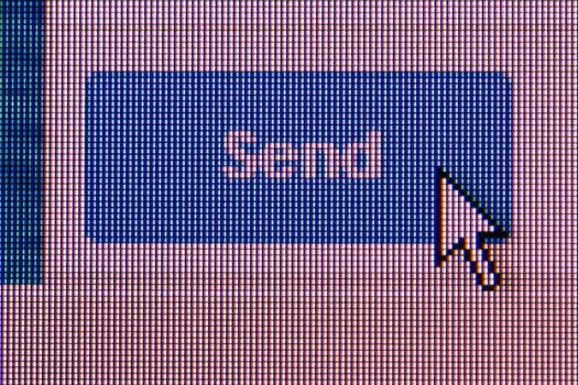 pushing send button. Macro screen view of old monitor