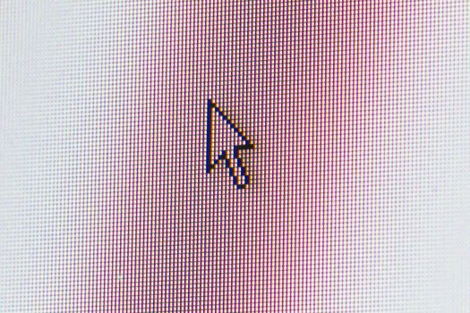 Close-up of cursor on monitor screen.