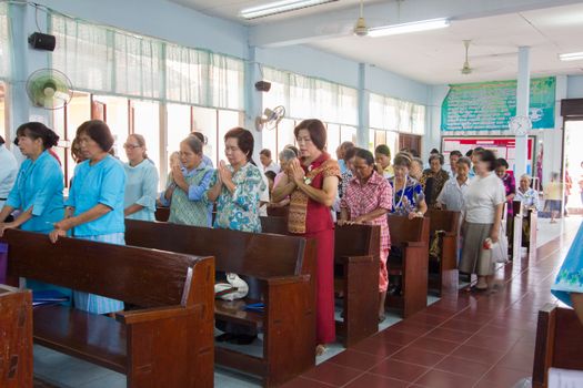 CHIANGRAI, THAILAND - AUG 10: unidentified people praying for Her Majesty Queen Sirikit in church on August 10, 2014 in Chiangrai, Thailand. Thai people in every religions always pray for the Queen in the occation of Her Mejesty Queen's Birthday (on August, 12)