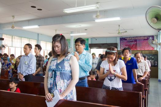 CHIANGRAI, THAILAND - AUG 10: unidentified people praying for Her Majesty Queen Sirikit in church on August 10, 2014 in Chiangrai, Thailand. Thai people in every religions always pray for the Queen in the occation of Her Mejesty Queen's Birthday (on August, 12)